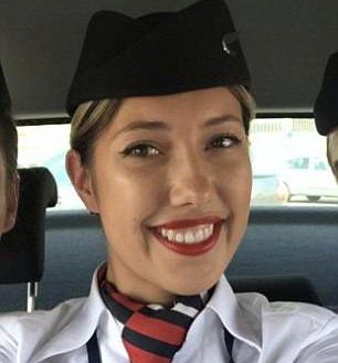 Cabin crew shows her tits.